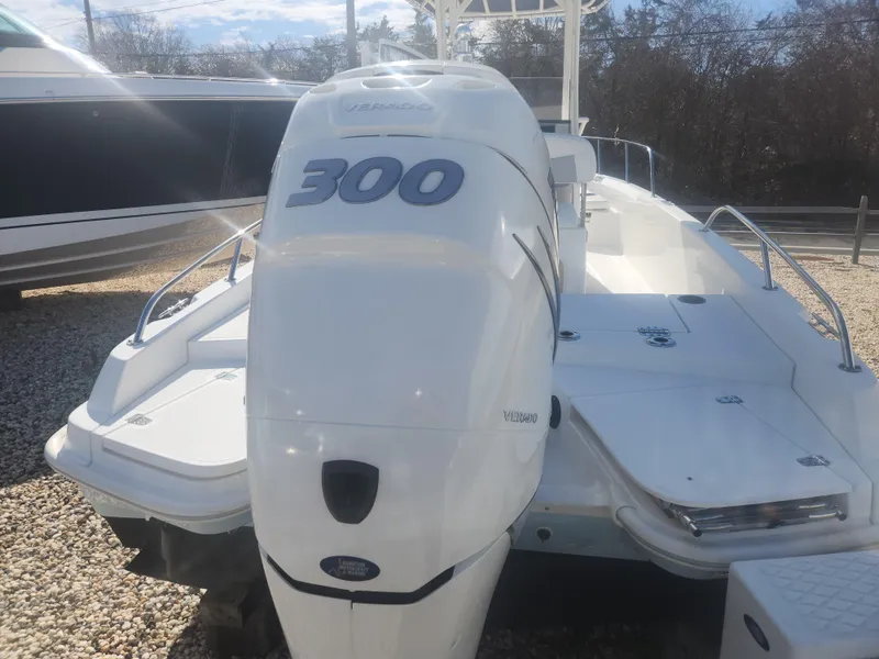 Slide: The Image of 2015 Boston Whaler 240 Dauntless boat with a 300 horsepower engine, docked outdoors. - 3
