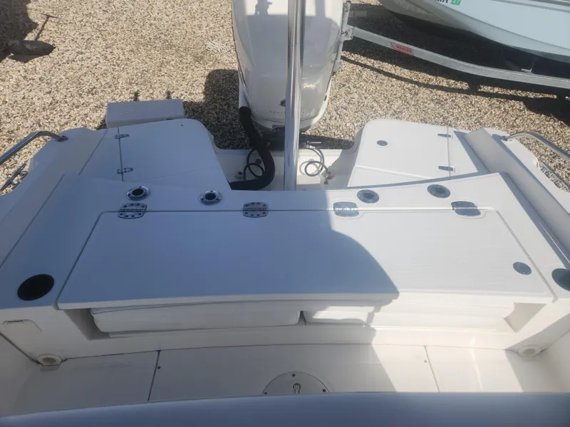 Slide: The Image of 2015 Boston Whaler 240 Dauntless boat deck with storage compartments and seating. - 4
