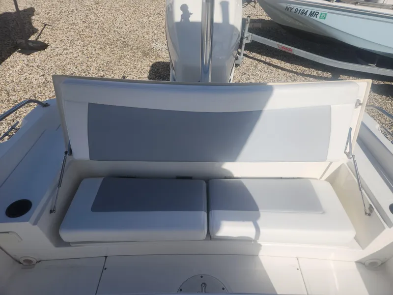 Slide: The Image of 2015 Boston Whaler 240 Dauntless boat seating area with gray and white cushions. - 5