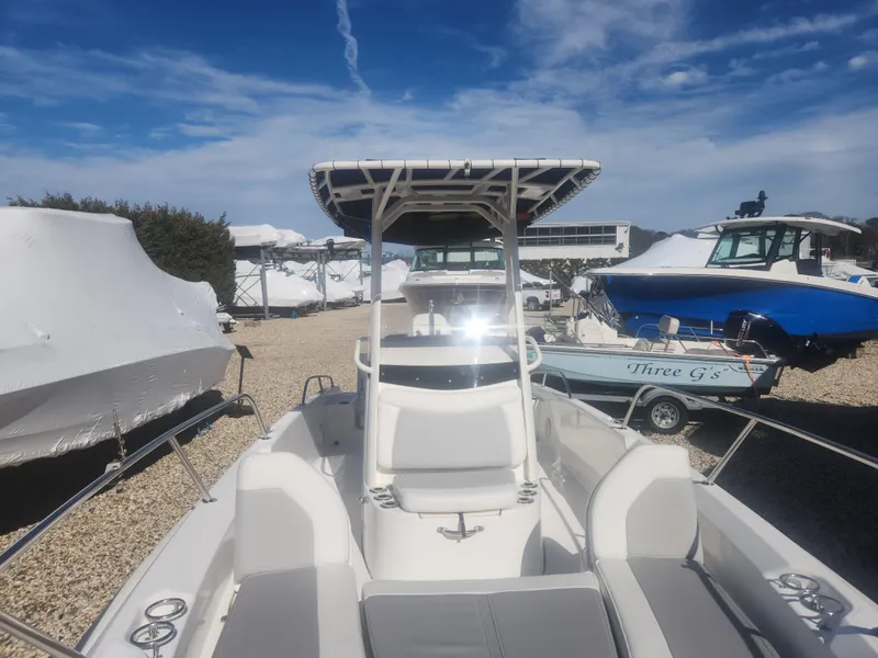 Slide: The Image of 2015 Boston Whaler 240 Dauntless boat in storage yard under clear blue sky. - 9