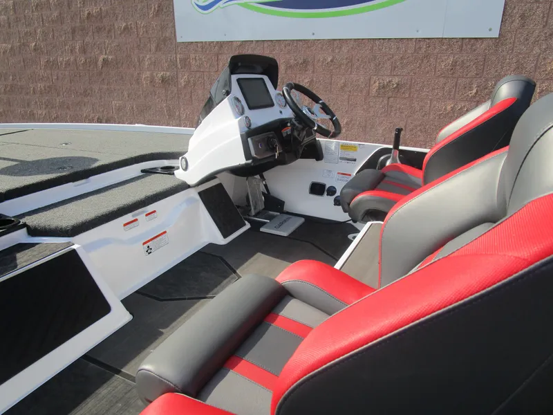 Slide: The Image of 2025 Nitro Z20 XL Pro boat interior with red and gray seating, steering console. - 24