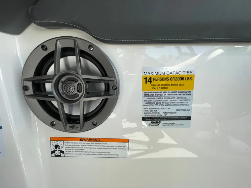 Slide: The Image of 2024 Chaparral 250 OSX boat speaker and capacity warning label, 14 persons or 2006 lbs. - 21