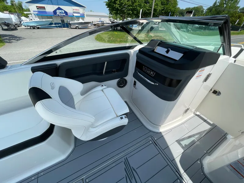 Slide: The Image of 2024 Chaparral 250 OSX boat interior with sleek seating and modern dashboard design. - 24