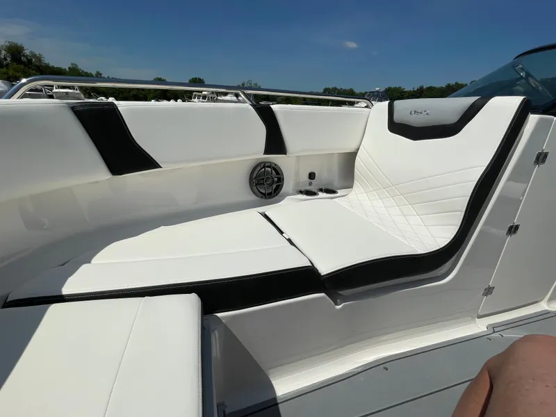 Slide: The Image of 2024 Chaparral 250 OSX boat interior with sleek white seating and black accents. - 10