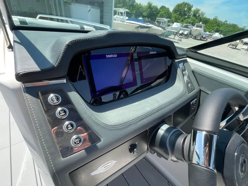 Slide: The Image of 2024 Chaparral 250 OSX dashboard with dual Simrad displays and control buttons. - 23