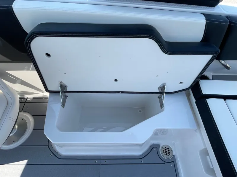 Slide: The Image of 2024 Chaparral 250 OSX boat storage compartment with open lid. - 42
