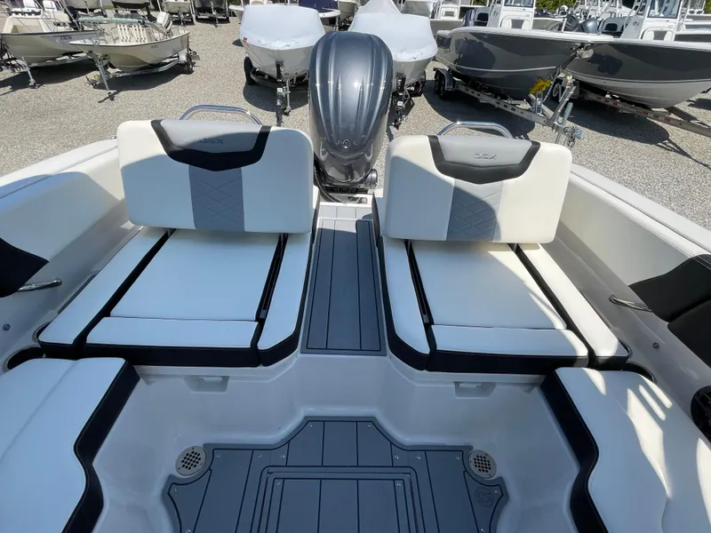 Slide: The Image of 2024 Chaparral 250 OSX boat interior with dual seating and sleek design. - 45