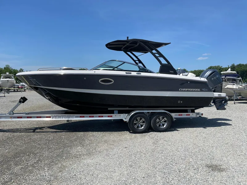 Slide: The Image of 2024 Chaparral 250 OSX boat on trailer, sleek black design, sunny day. - 0