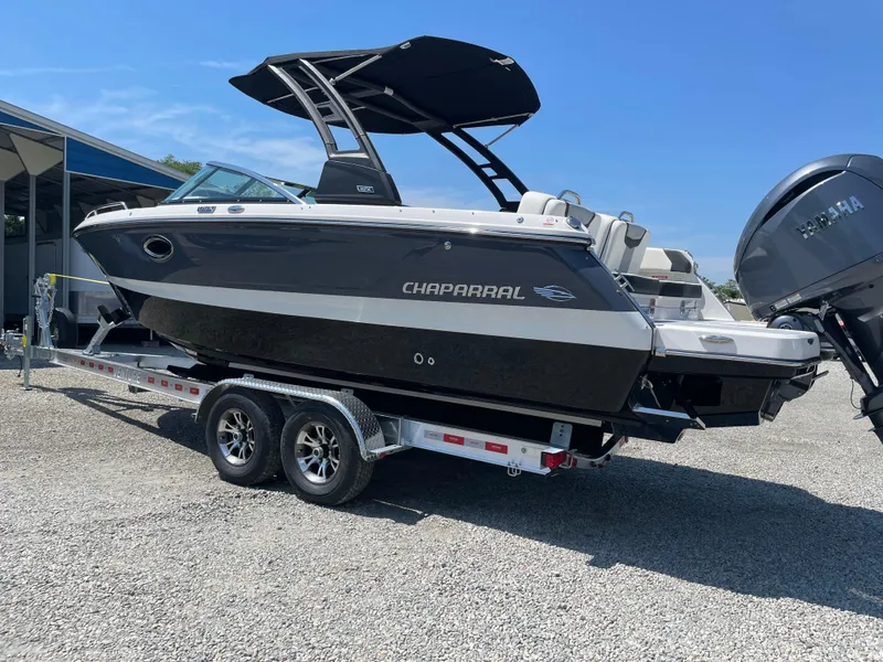 Slide: The Image of 2024 Chaparral 250 OSX boat on trailer, sleek design, black and white exterior, outdoor display. - 1