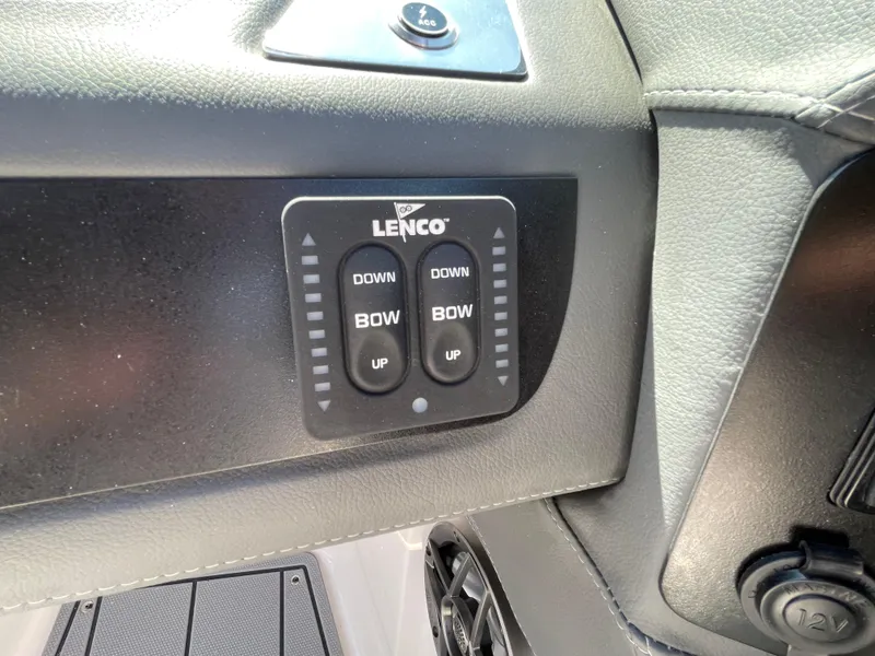 Slide: The Image of Lenco trim tab controls on 2024 Chaparral 250 OSX boat dashboard. - 26