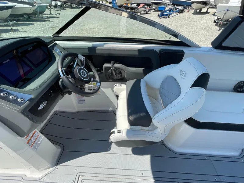 Slide: The Image of 2024 Chaparral 250 OSX boat interior with steering wheel and captain's seat. - 29