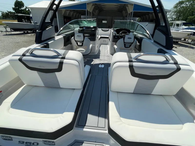Slide: The Image of 2024 Chaparral 250 OSX boat interior with white seating and modern design. - 38