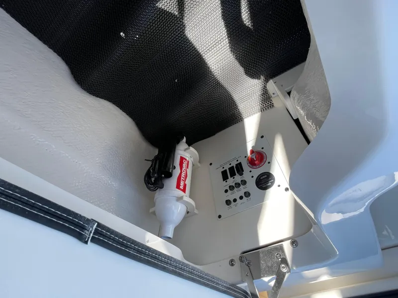 Slide: The Image of 2024 Chaparral 250 OSX boat interior control panel and fire extinguisher. - 44