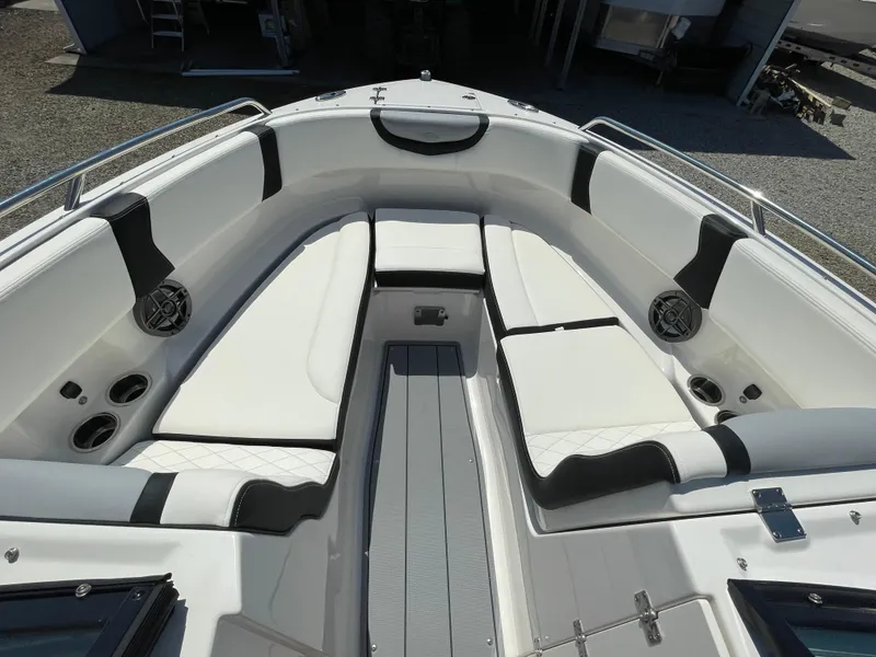 Slide: The Image of 2024 Chaparral 250 OSX boat interior with white seating and cup holders. - 7