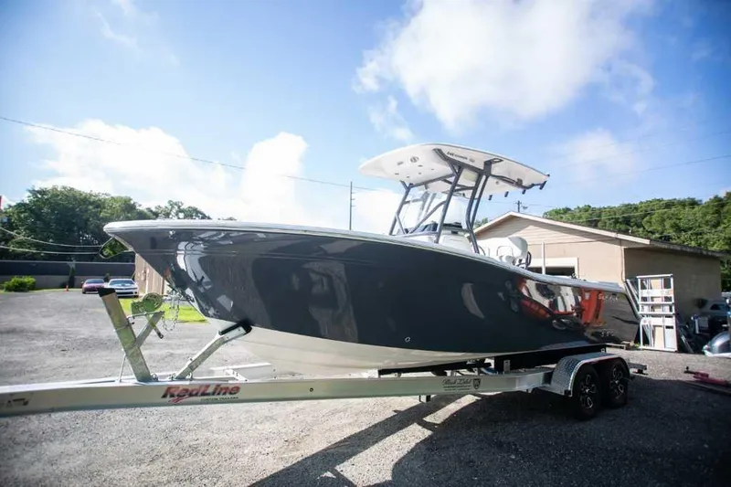 Slide: The Image of 2022 Sea Fox 248 Commander boat on trailer under clear blue sky. - 0