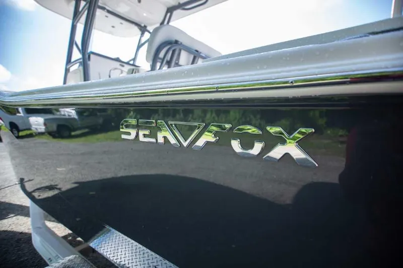 Slide: The Image of 2022 Sea Fox 248 Commander boat with chrome logo detail. - 2