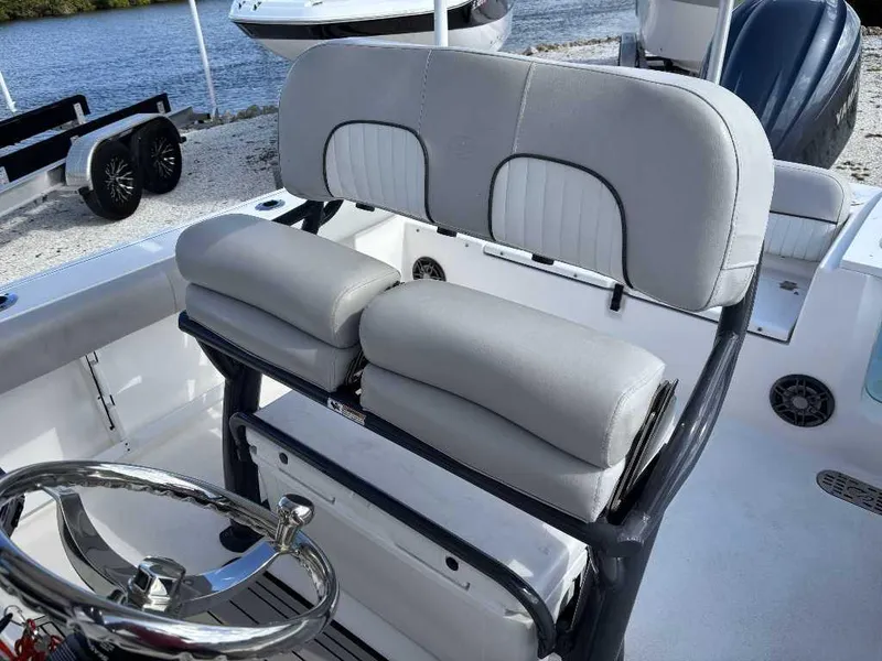 Slide: The Image of 2022 Sea Fox 248 Commander boat interior with cushioned seating and steering wheel. - 4