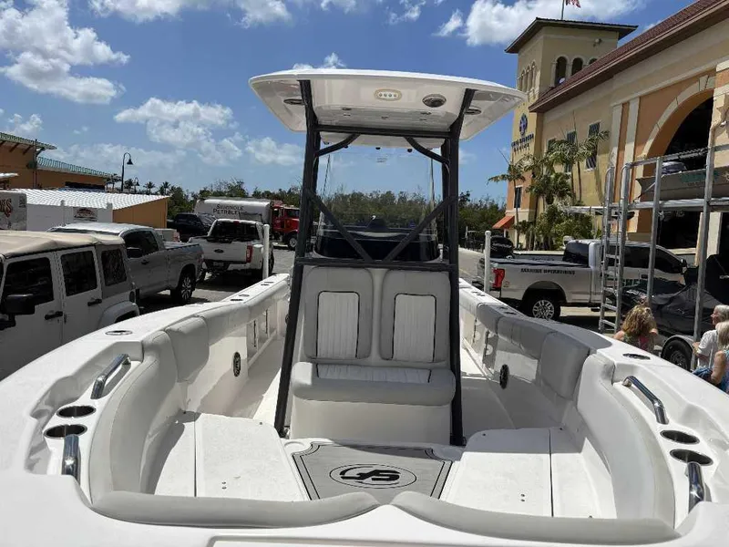 Slide: The Image of 2022 Sea Fox 248 Commander boat at a marina, under a clear blue sky. - 6