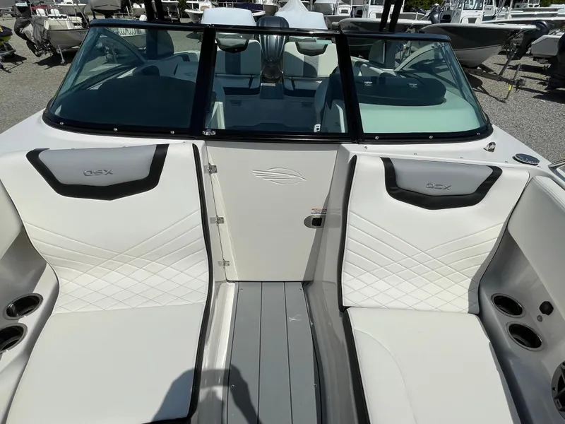 Slide: The Image of 2024 Chaparral 250 OSX boat interior with white seating and cup holders. - 19