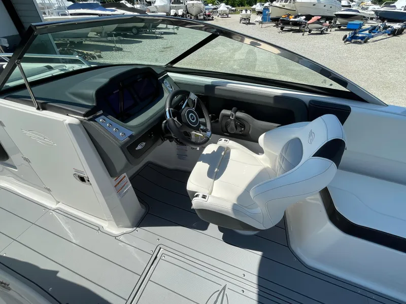 Slide: The Image of 2024 Chaparral 250 OSX boat cockpit with modern steering and seating. - 21