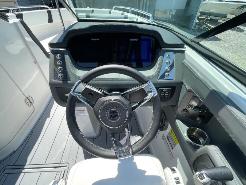 Slide: The Image of 2024 Chaparral 250 OSX boat cockpit with modern steering wheel and dashboard controls. - 22