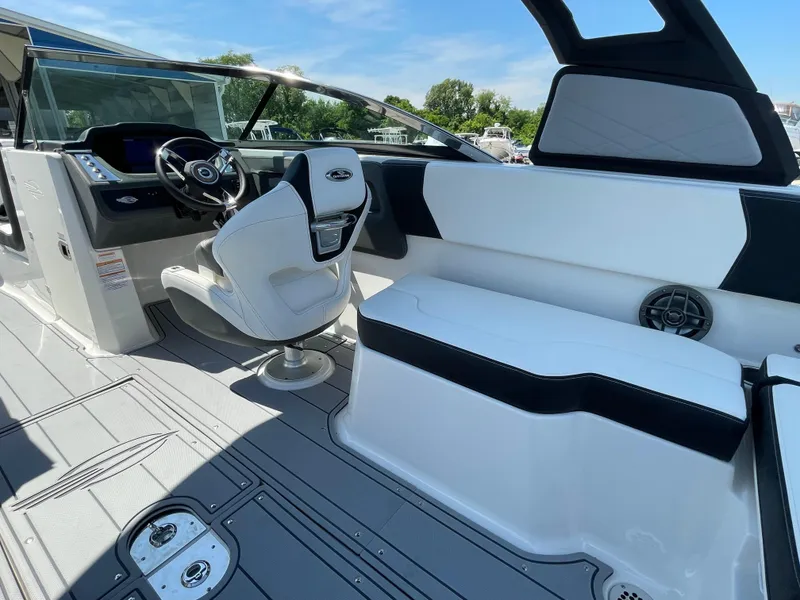 Slide: The Image of 2024 Chaparral 250 OSX boat interior with modern seating and steering console. - 35