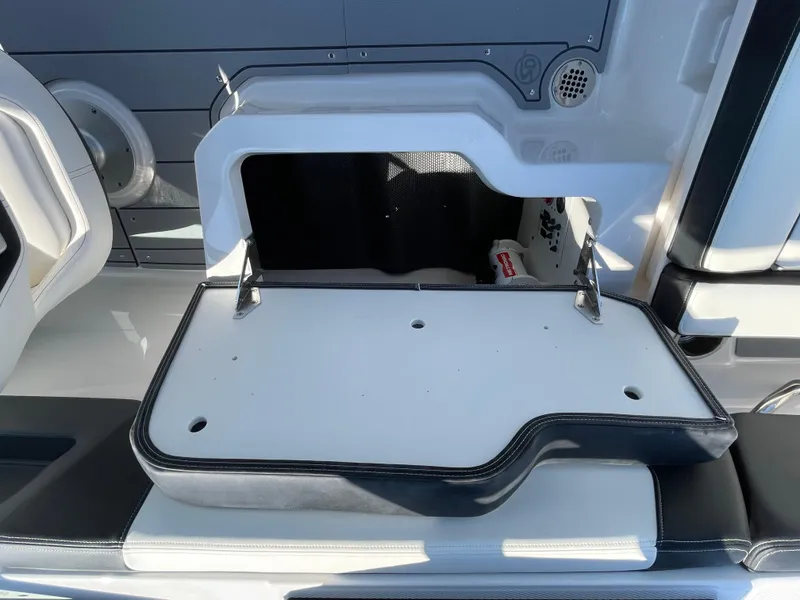 Slide: The Image of 2024 Chaparral 250 OSX boat storage compartment with open lid. - 43