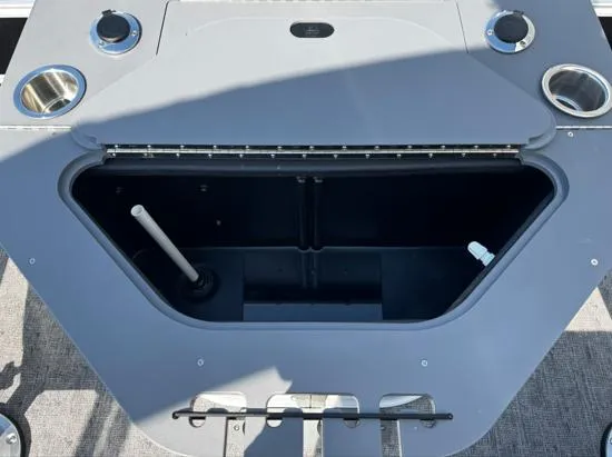 Slide: The Image of 2025 South Bay 224FCR LE boat storage compartment with cup holders and utility features. - 8