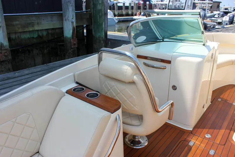 Slide: The Image of 2016 Chris-Craft Launch 25 boat interior with elegant seating and wooden deck. - 11