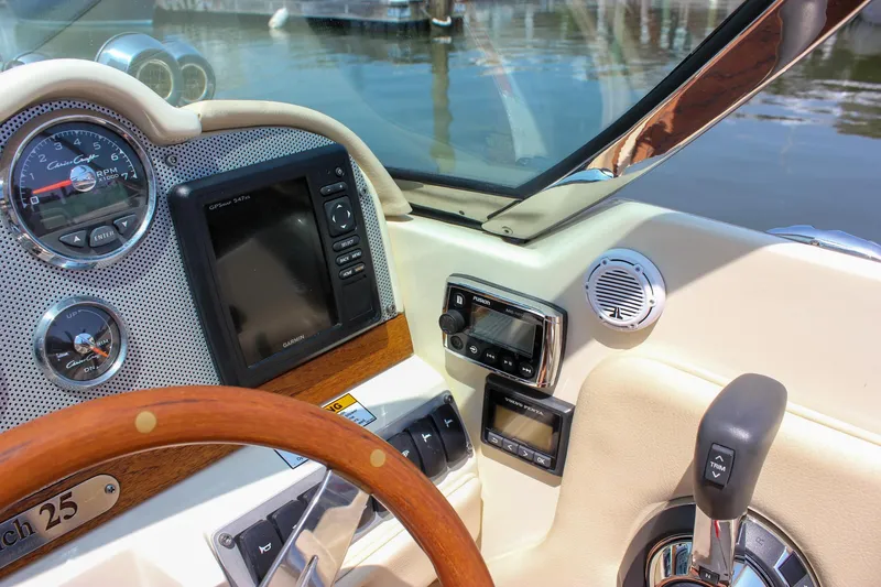 Slide: The Image of 2016 Chris-Craft Launch 25 dashboard with steering wheel and navigation controls. - 17