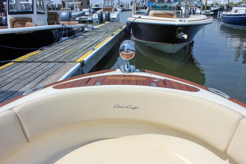 Slide: The Image of 2016 Chris-Craft Launch 25 boat docked at marina, showcasing elegant design and craftsmanship. - 21