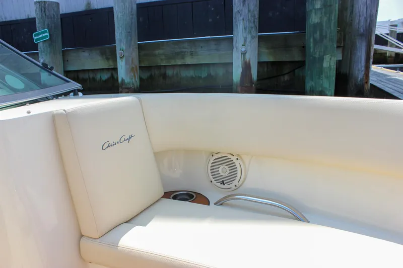 Slide: The Image of 2016 Chris-Craft Launch 25 boat interior with beige seating and speaker. - 23