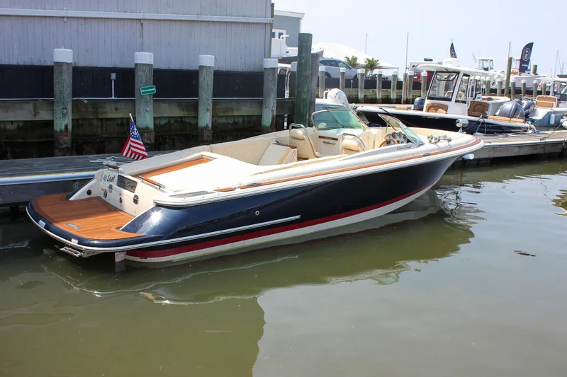 Slide: The Image of 2016 Chris-Craft Launch 25 boat docked, featuring sleek design and luxurious seating. - 34