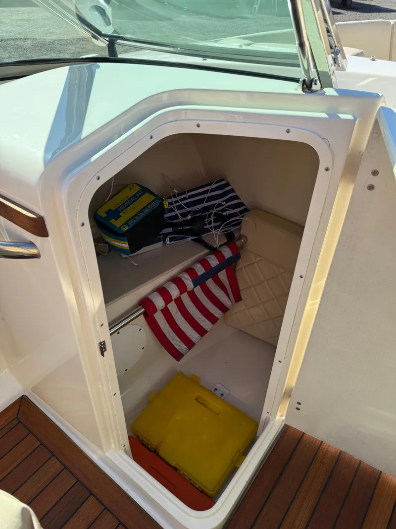 Slide: The Image of 2016 Chris-Craft Launch 25 storage compartment with colorful life jackets and accessories. - 41