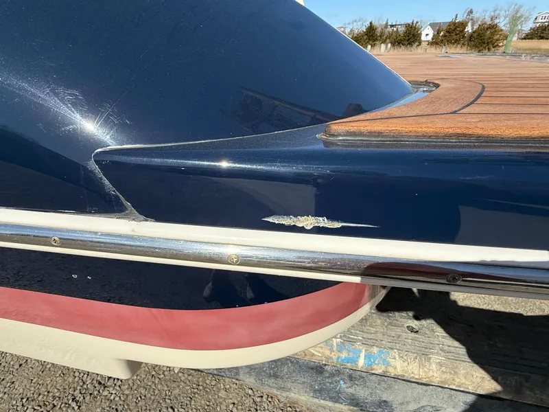Slide: The Image of 2016 Chris-Craft Launch 25 boat with visible hull damage and wooden deck detail. - 49