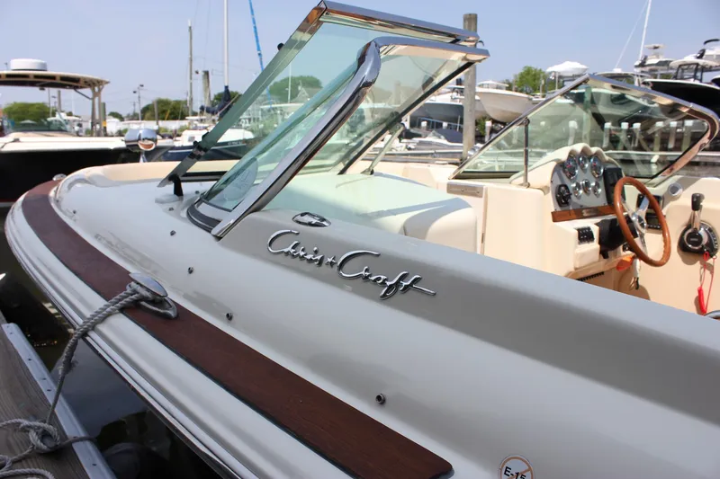Slide: The Image of 2016 Chris-Craft Launch 25 boat with elegant design and wooden accents docked at marina. - 5