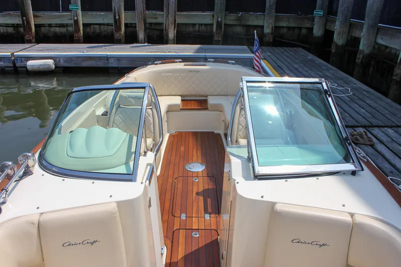 Slide: The Image of 2016 Chris-Craft Launch 25 boat with elegant wood deck and seating, docked at marina. - 7