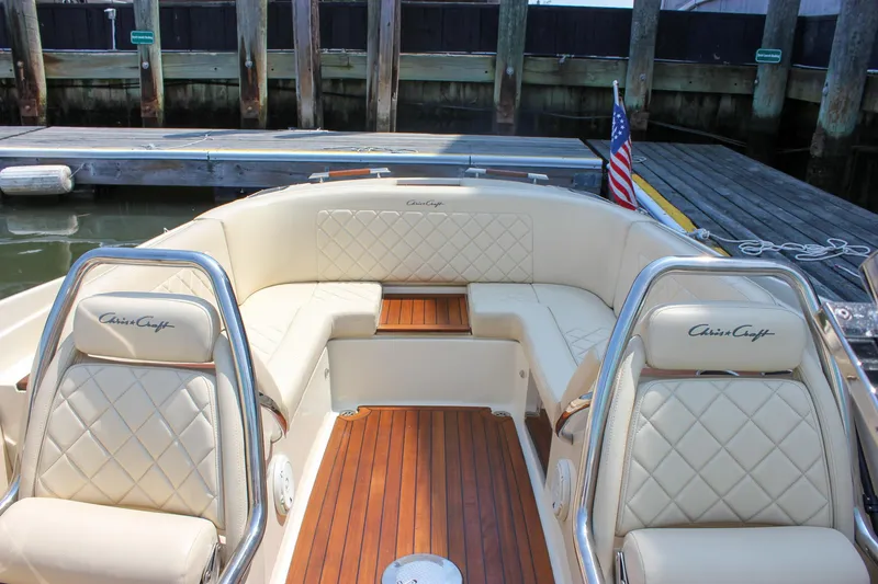 Slide: The Image of 2016 Chris-Craft Launch 25 boat interior with luxurious seating and wooden deck. - 8