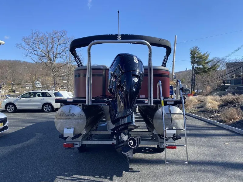 Slide: The Image of 2023 Viaggio Lago U L20U pontoon boat with outboard motor, parked outdoors. - 3