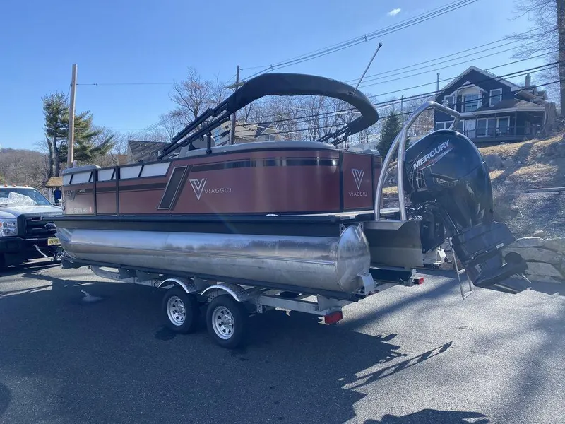 Slide: The Image of 2023 Viaggio Lago U L20U pontoon boat on trailer, parked outdoors. - 4