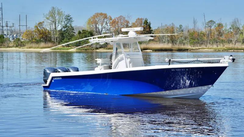 Slide: The Image of 2015 Contender 35 ST boat on calm water, featuring a sleek blue hull. - 0
