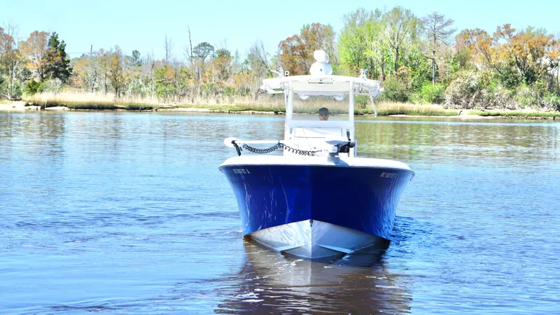 Slide: The Image of 2015 Contender 35 ST boat on calm water, surrounded by trees. - 1