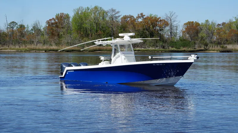 Slide: The Image of 2015 Contender 35 ST boat on calm water, featuring a sleek blue hull. - 3