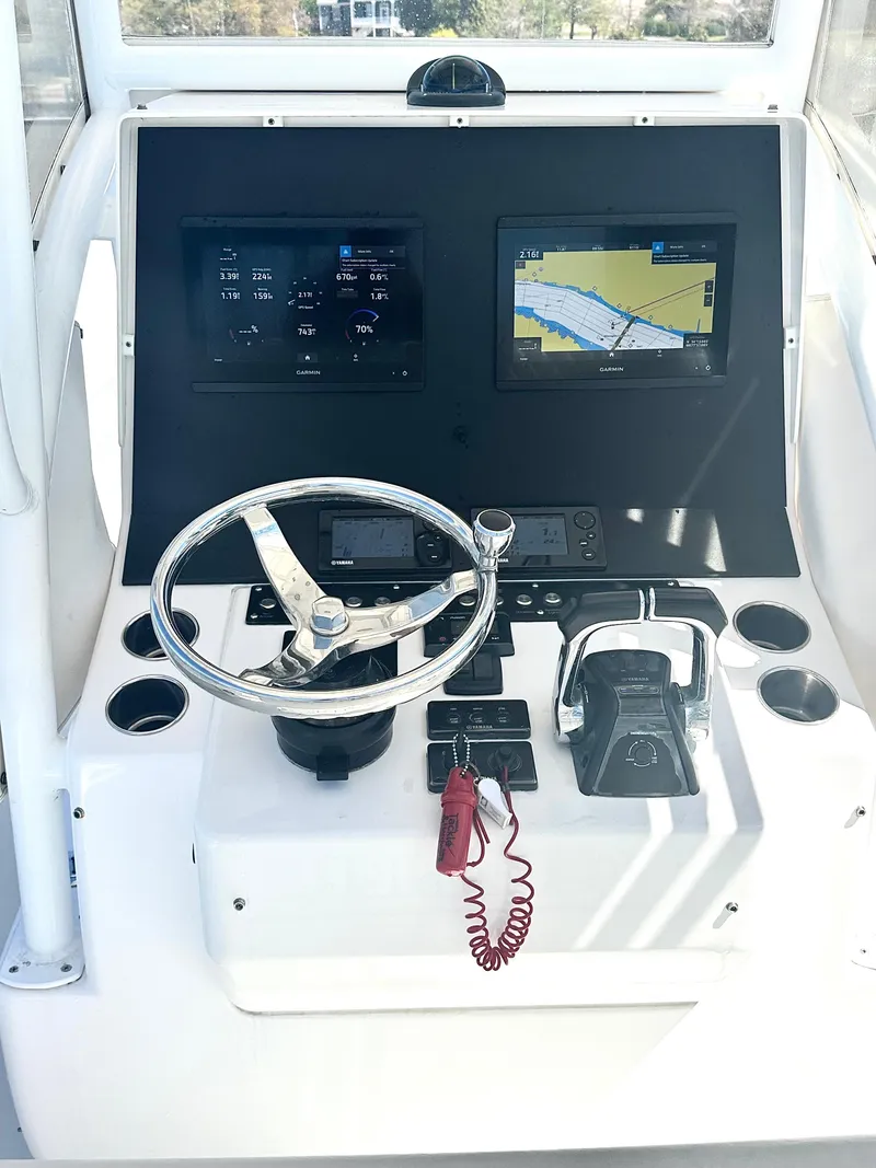 Slide: The Image of 2015 Contender 35 ST boat dashboard with navigation screens and steering wheel. - 5