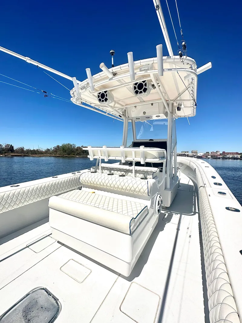 Slide: The Image of 2015 Contender 35 ST boat with white seating and canopy on a sunny day. - 7