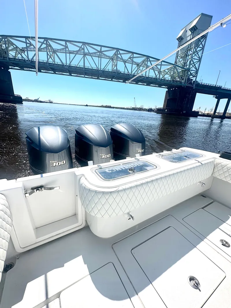 Slide: The Image of 2015 Contender 35 ST boat with triple engines near a bridge on a sunny day. - 8
