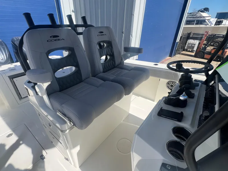 Slide: The Image of 2025 Cobia 285 Open Center Console boat interior with dual seats and steering console. - 12