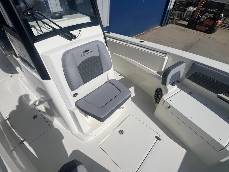 Slide: The Image of 2025 Cobia 285 Open Center Console boat interior with seating and storage compartments. - 13