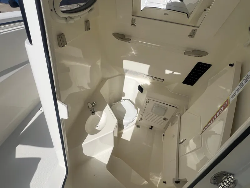 Slide: The Image of 2025 Cobia 285 Open Center Console interior cabin with modern amenities and sleek design. - 17
