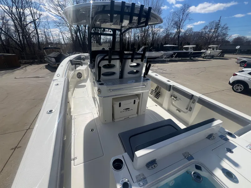 Slide: The Image of 2025 Cobia 285 Open Center Console boat in a sunny outdoor setting. - 5
